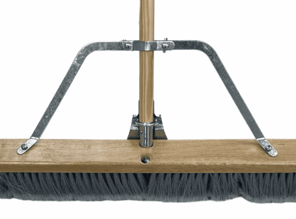 A push broom with a wooden handle and black bristles.