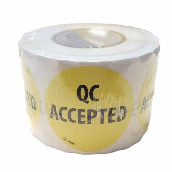 Roll of QC Accepted stickers with yellow background.