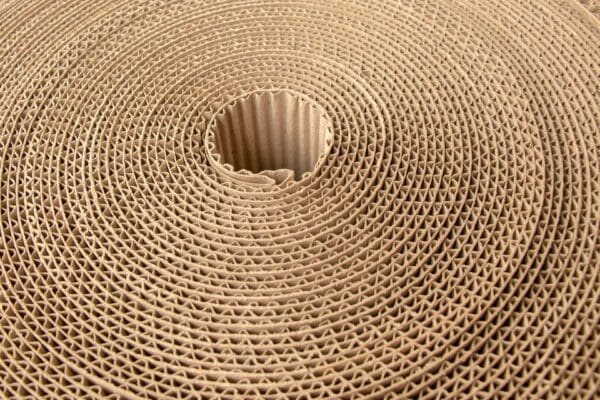 Close-up of a tightly coiled corrugated cardboard roll.