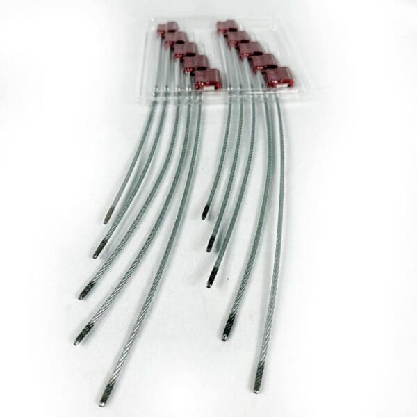 Set of flexible fiber optic cables with red connectors.